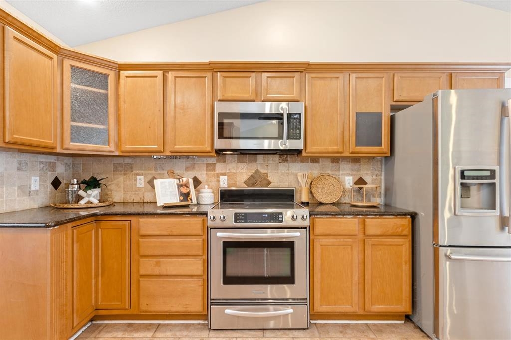 205 Shirley's Way St. Augustine, FL 32086 - Photo 11 of 56 a kitchen with granite countertop a refrigerator stove and microwave