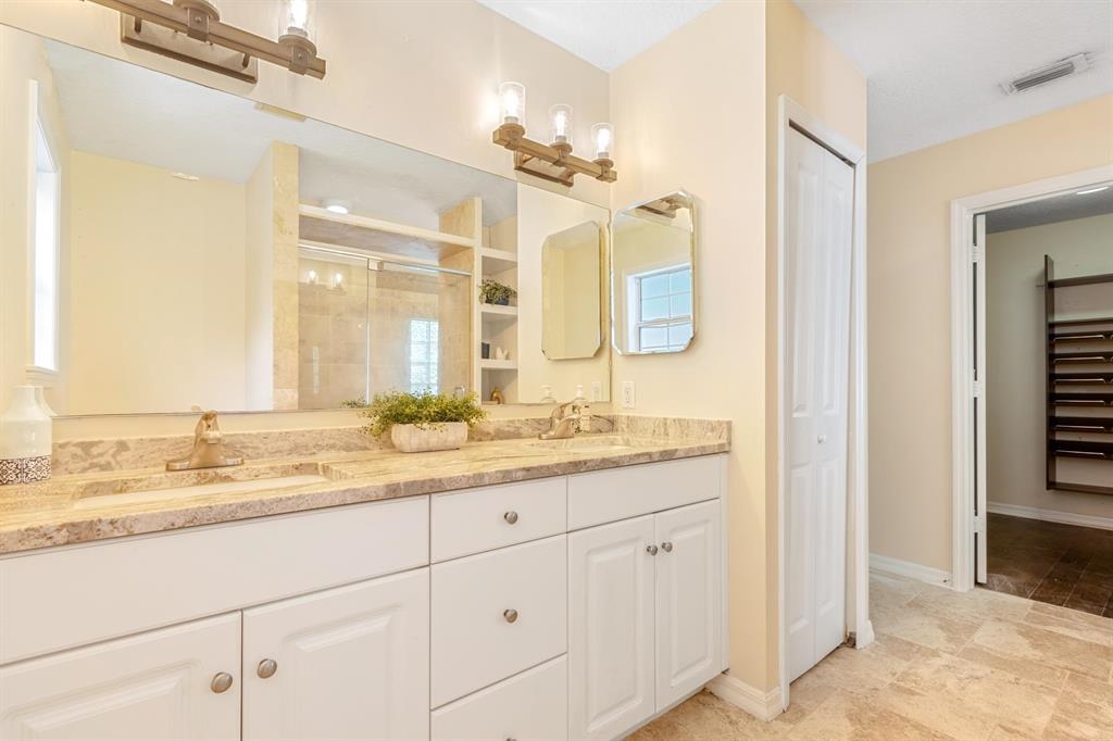 205 Shirley's Way St. Augustine, FL 32086 - Photo 22 of 56 a bathroom with a granite countertop sink mirror and