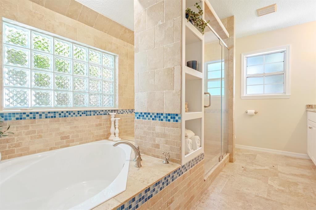 205 Shirley's Way St. Augustine, FL 32086 - Photo 24 of 56 a bathroom with a bathtub and a shower