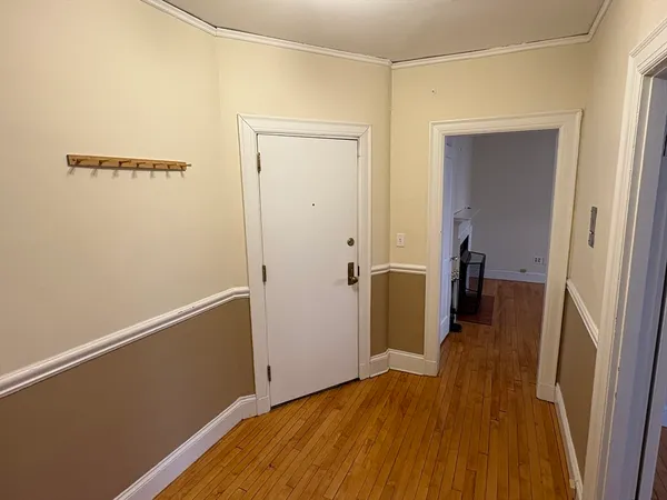 a view of a room with wooden floor