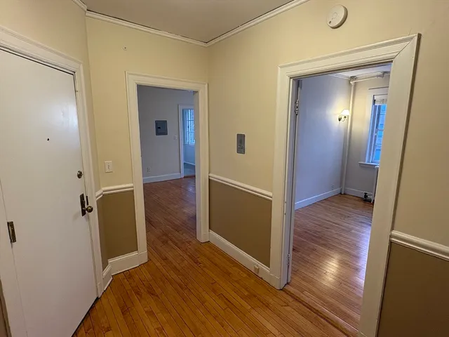a view of hallway with wooden floor