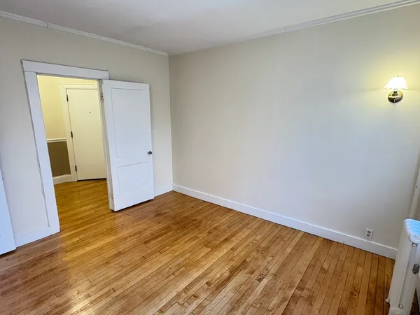 a view of an empty room and wooden floor