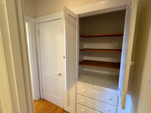 a view of walk in closet with empty racks