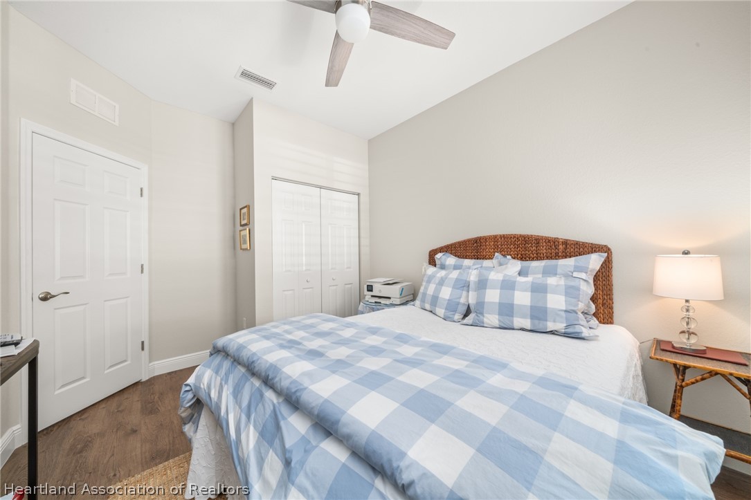 4734 Haw Branch Road, Unit 110 Sebring, FL 33875 - Photo 28 of 50 a bedroom with a bed and lamp