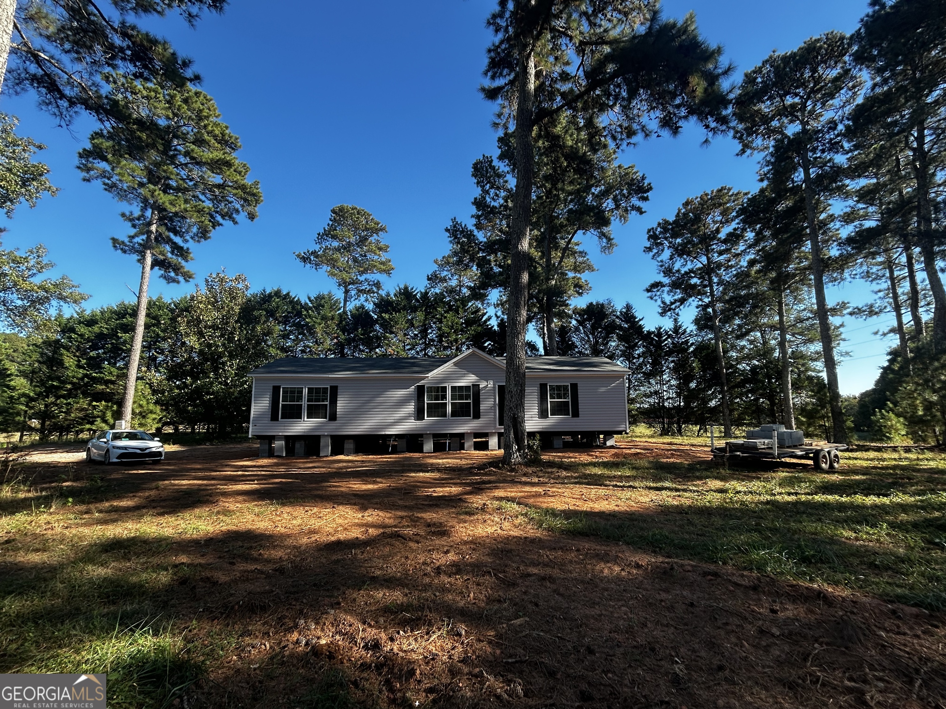 a view of a house with pool and sitting area