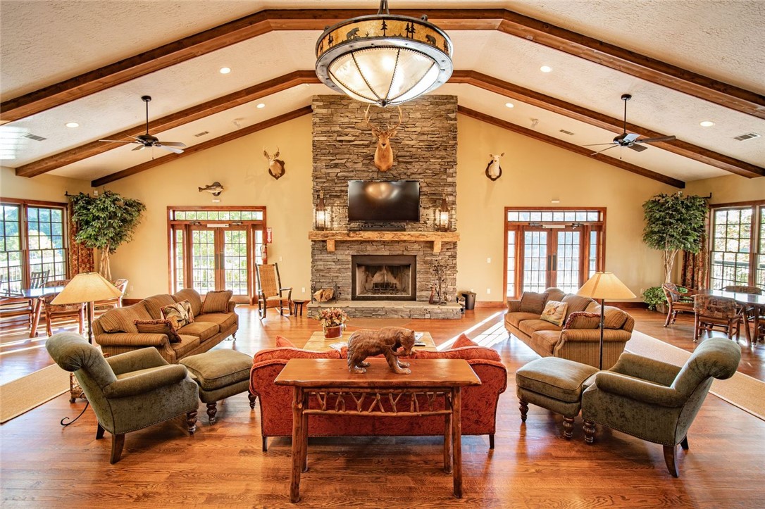 1230 Melton Road, Unit 82 West Union, SC 29696 - Photo 38 of 50 This inviting lodge great room features high ceilings and a prominent stone fireplace, perfect for gatherings.