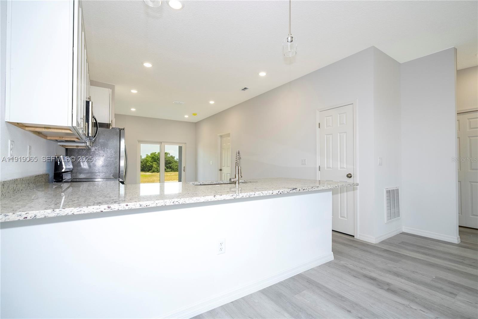 873 Colville Drive, Unit 873 Kissimmee, FL 34759 - Photo 11 of 47 a kitchen with a sink a counter top and stainless steel appliances