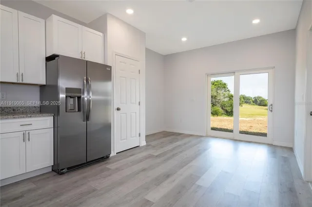 a kitchen with stainless steel appliances granite countertop a refrigerator and a stove