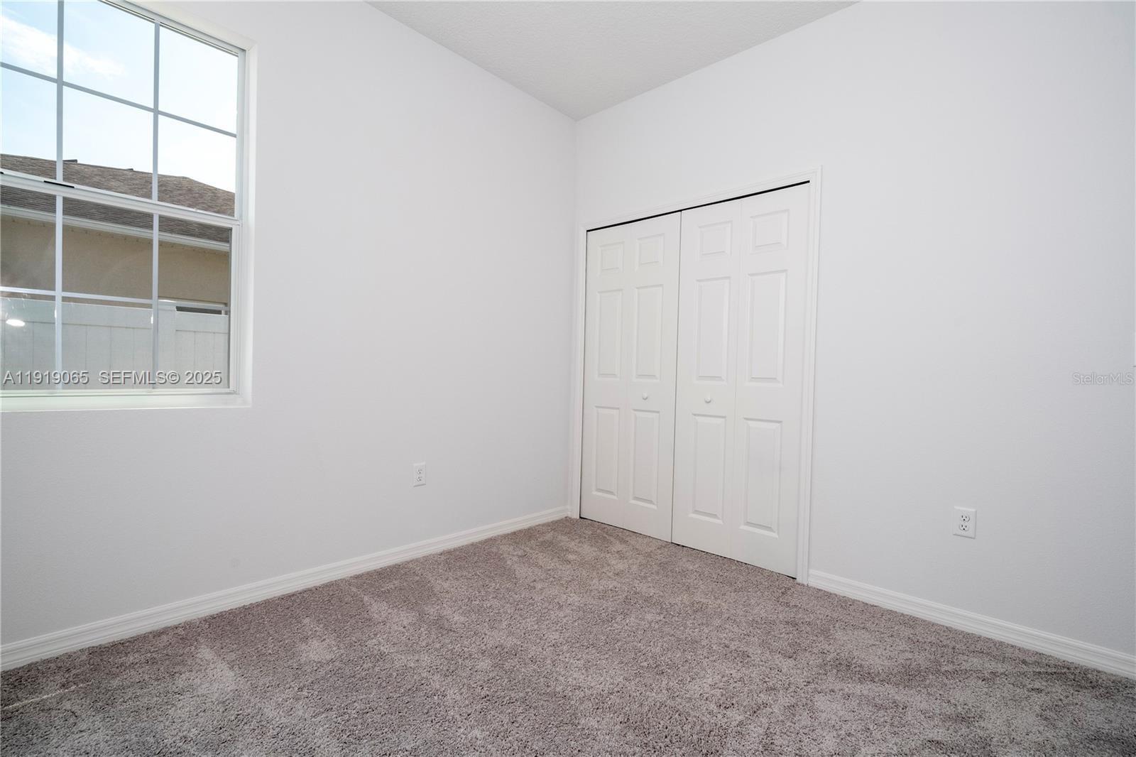 873 Colville Drive, Unit 873 Kissimmee, FL 34759 - Photo 34 of 47 an empty room with a window