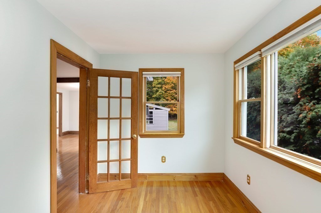 79 Dalton Road Chelmsford, MA 01824 - Photo 27 of 40 a view of an empty room with wooden floor and a window
