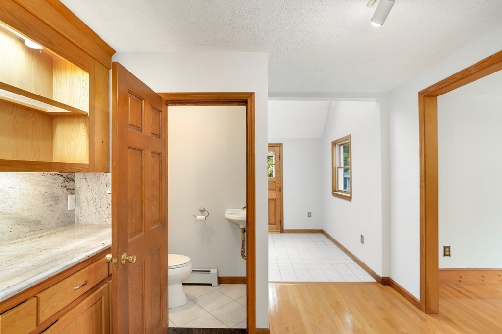 79 Dalton Road Chelmsford, MA 01824 - Photo 33 of 40 a view of a hallway with wooden floor and a living room