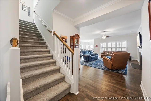 a living room with furniture or stairs and a wooden floor