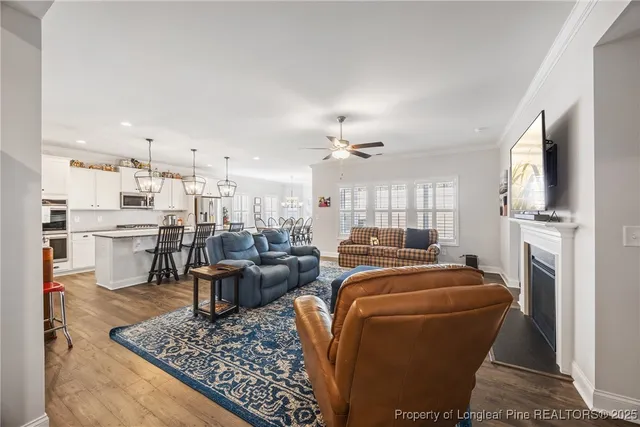 a living room with fireplace furniture and a flat screen tv