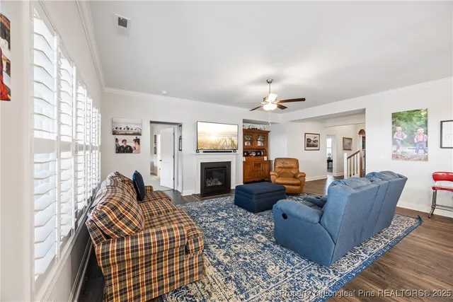 a living room with furniture a fireplace and a large window