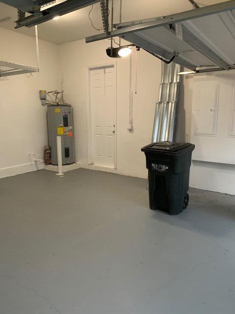 6729 Bulrush Court Greenacres, FL 33413 - Photo 12 of 35 a view of an empty room with wooden floor and windows