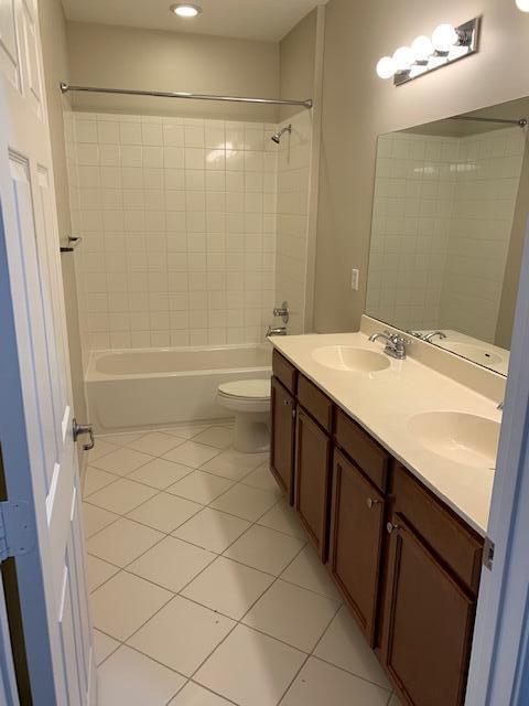 6729 Bulrush Court Greenacres, FL 33413 - Photo 17 of 35 a bathroom with a sink a toilet a mirror and shower
