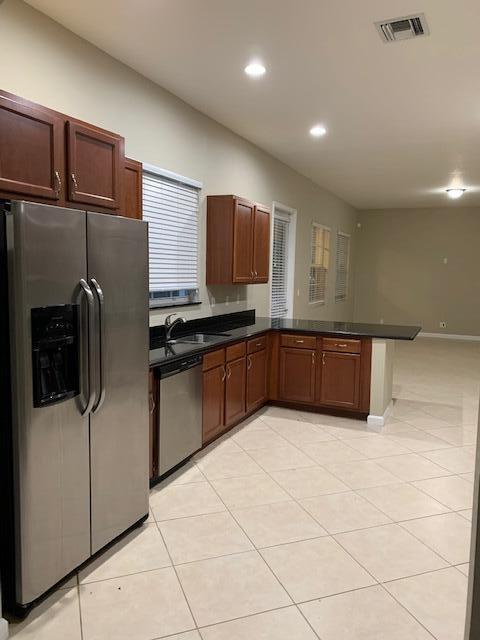 6729 Bulrush Court Greenacres, FL 33413 - Photo 19 of 35 a kitchen with stainless steel appliances granite countertop a refrigerator and a sink