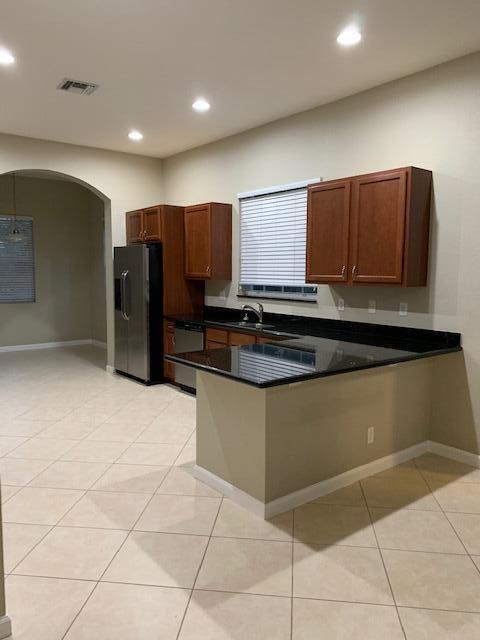 6729 Bulrush Court Greenacres, FL 33413 - Photo 20 of 35 a kitchen with stainless steel appliances granite countertop a refrigerator and a stove