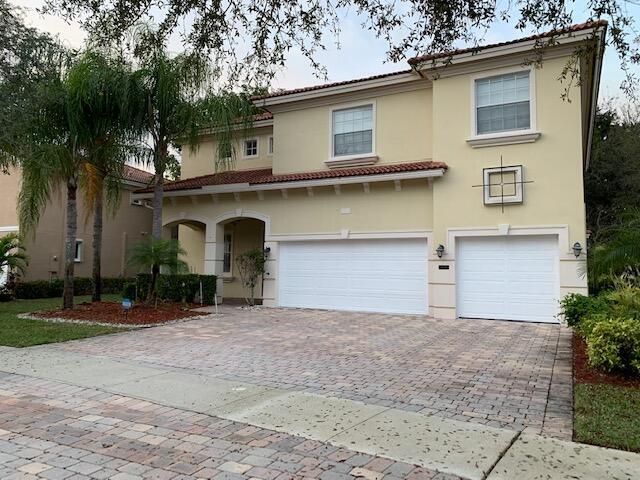 6729 Bulrush Court Greenacres, FL 33413 - Photo 2 of 35 a view of a house with a yard and garage