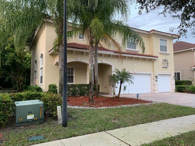 6729 Bulrush Court Greenacres, FL 33413 - Photo 3 of 35 a view of a yard in front of a house with a large tree