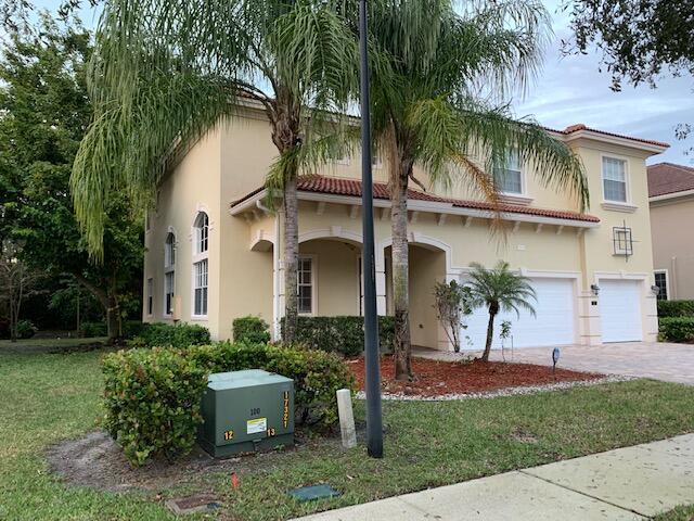 6729 Bulrush Court Greenacres, FL 33413 - Photo 4 of 35 a front view of a house with a garden
