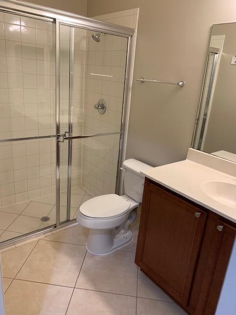 6729 Bulrush Court Greenacres, FL 33413 - Photo 7 of 35 a bathroom with a toilet and a shower