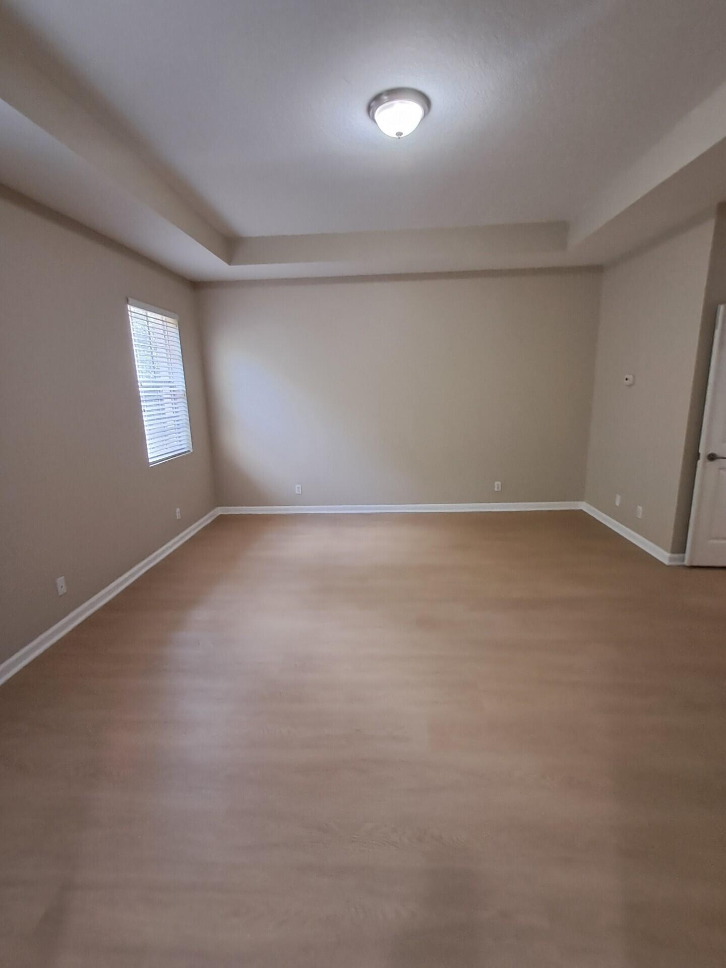 6729 Bulrush Court Greenacres, FL 33413 - Photo 9 of 35 an empty room with a empty space and windows