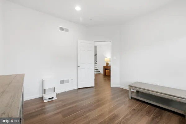a view of a room with wooden floor