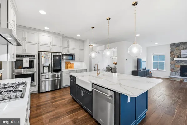 a large kitchen with stainless steel appliances kitchen island a large island in the center
