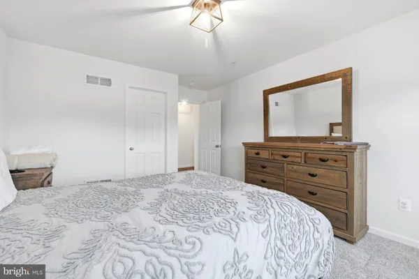 a bedroom with a bed and a dresser