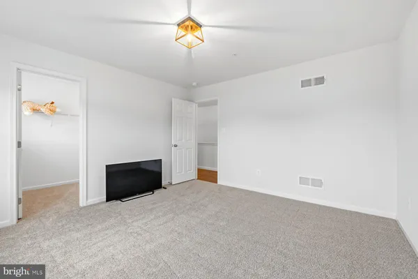 a view of an empty room with a cabinet