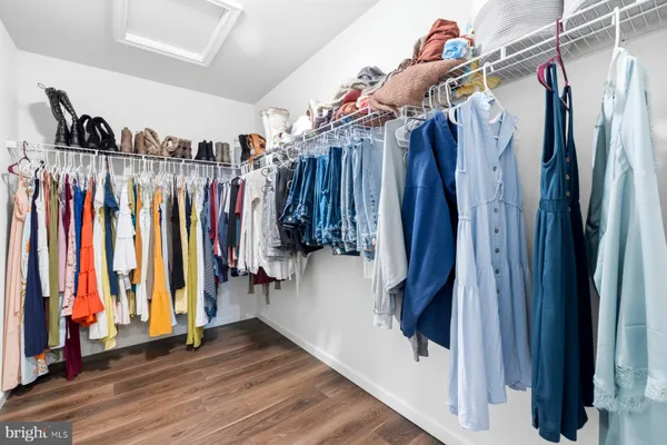 a view of walk in closet with clothes