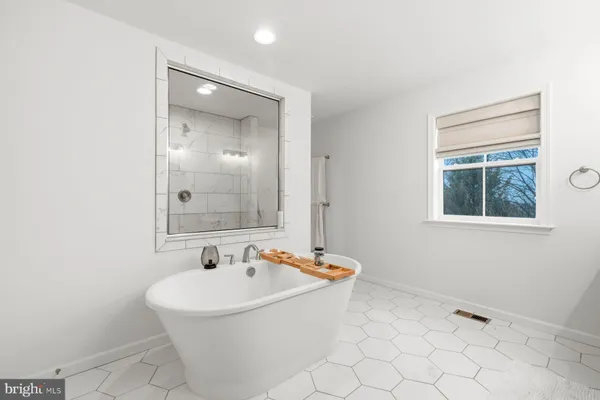 a bathroom with a bathtub and a sink