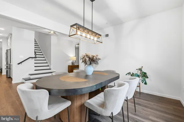 a view of a dining room with furniture wooden floor and chandelier