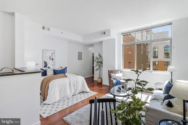 a bedroom with furniture and wooden floor