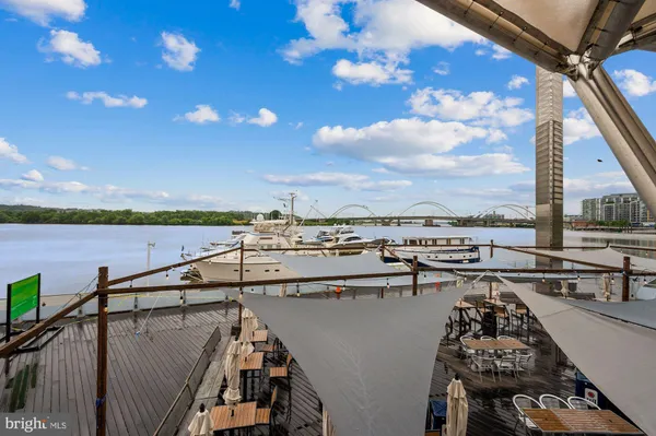 a store with outdoor seating area and flowers