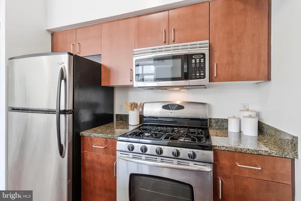 a kitchen with cabinets and stainless steel appliances