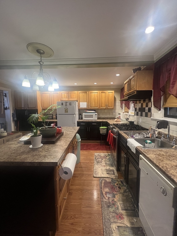 48 Leonard Street Boston, MA 02122 - Photo 2 of 2 a kitchen with stainless steel appliances granite countertop a sink a stove and a refrigerator