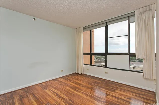 an empty room with wooden floor and a window