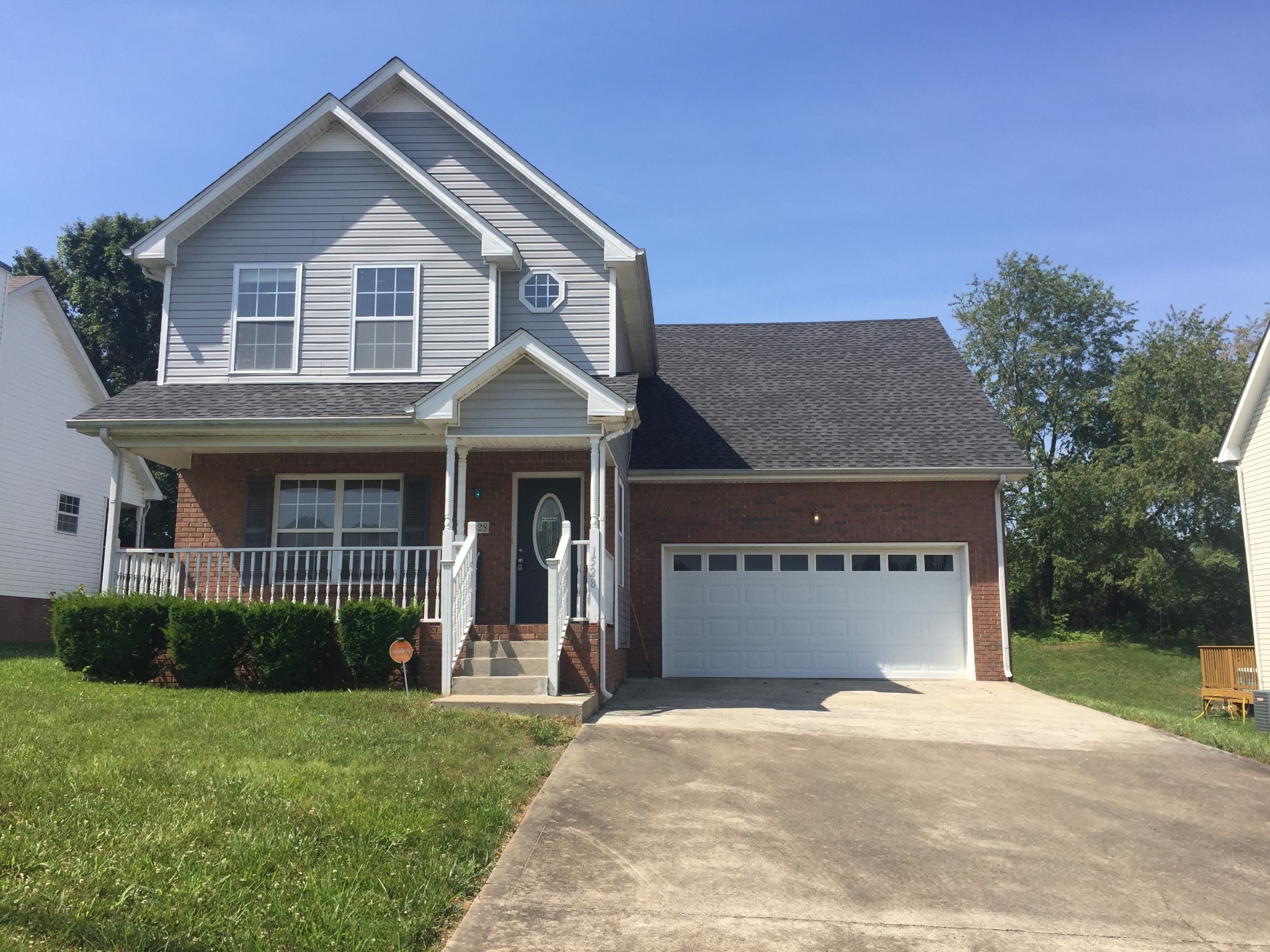 a front view of a house with a garden and yard