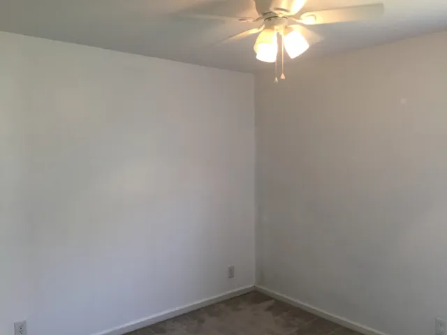 a small space with a window and a fan