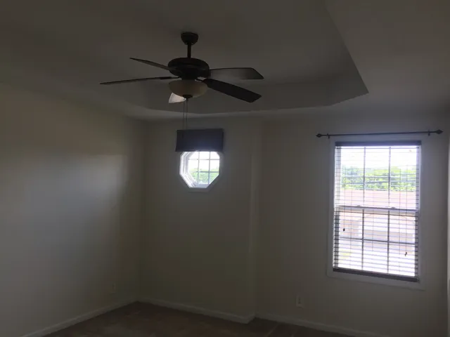 a view of hallway with chandelier fan