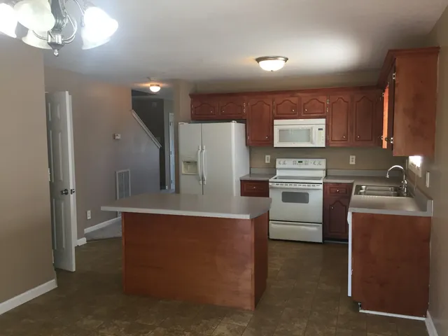 a kitchen with cabinets a sink and stainless steel appliances