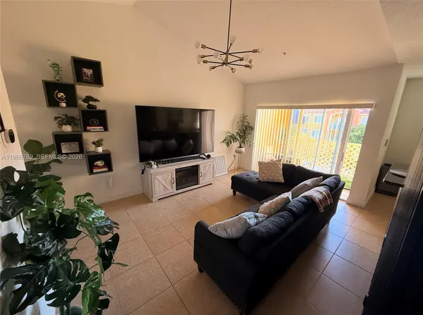 a living room with furniture and a flat screen tv