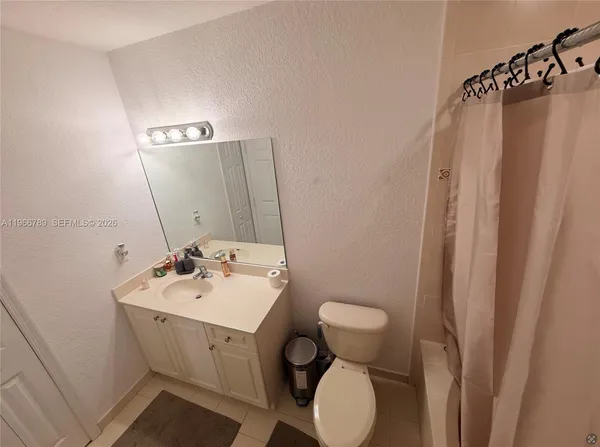 a bathroom with a sink mirror and toilet