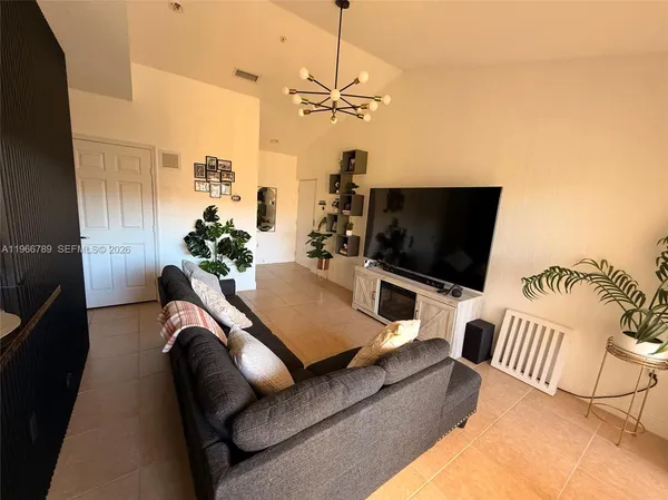 a living room with furniture and a flat screen tv
