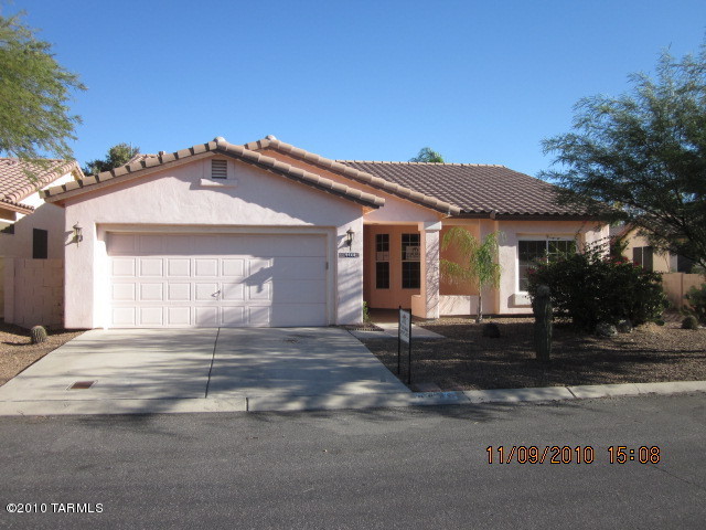 9920 North Stratton Saddle Trail Tucson, AZ 85742 - Photo 1 of 10 a front view of a house with a yard