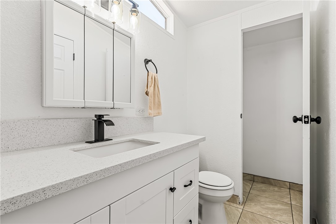 1655 Dunlap Road Fort Mohave, AZ 86426 - Photo 22 of 37 a bathroom with a sink vanity and toilet