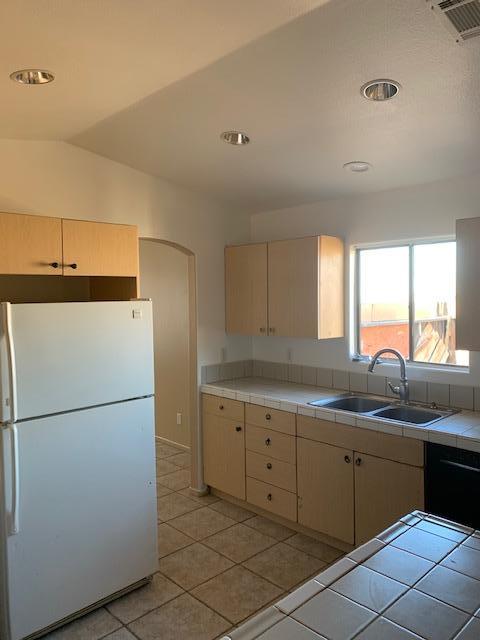 66844 8th Street Desert Hot Springs, CA 92240 - Photo 2 of 6 a kitchen with a sink and refrigerator