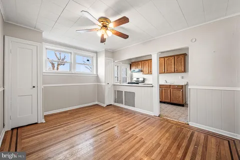 a view of a kitchen with wooden floor electronic appliances and window